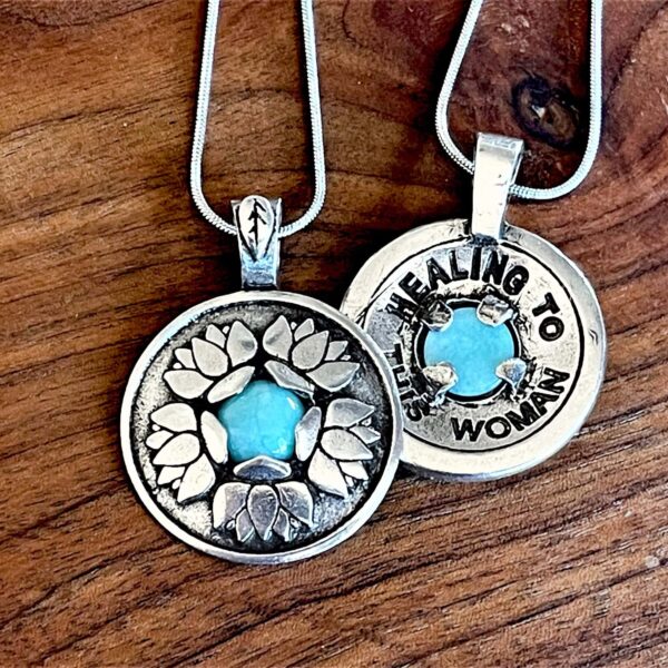 Two silver Healing Pendants with turquoise stones on them.