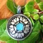 A Healing Pendant with a lotus flower on it.