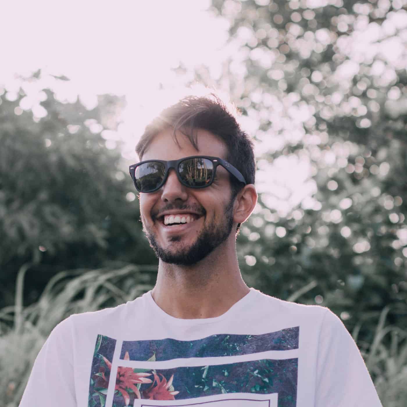 A man smiling with sunglasses.