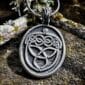 A pendant with a celtic knot on it.