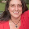 A woman wearing a red shirt.