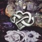 A heart shaped pendant with an infinity symbol on it.