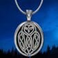 An owl pendant with a moon in the background.