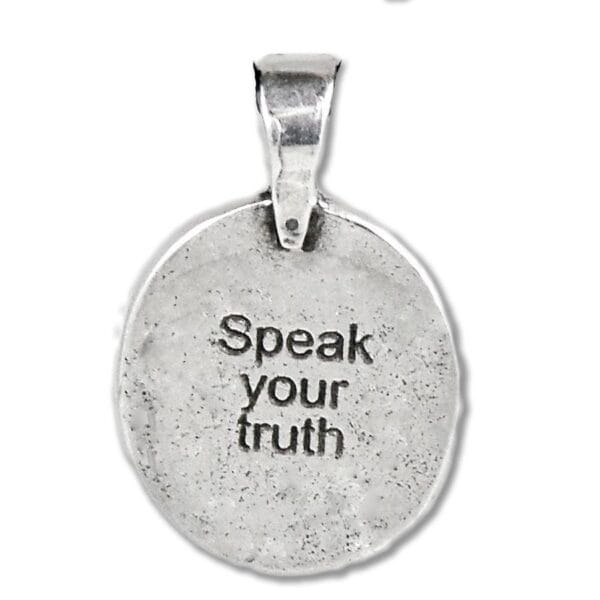 A silver pendant that says speak your truth.