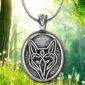 The celtic wolf pendant is shown in the woods.