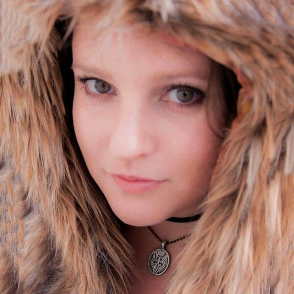 A woman wearing a furry hood.