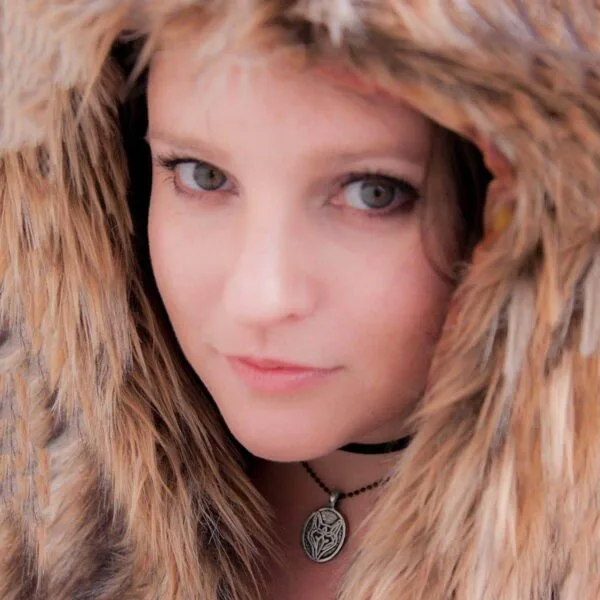 A woman wearing a furry hood.