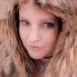 A woman wearing a furry hood.