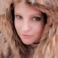 A woman wearing a furry hood.