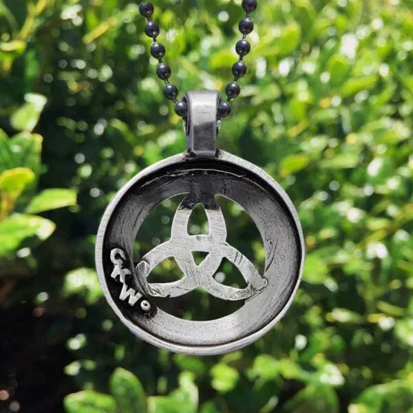 A celtic trinity necklace with a celtic symbol on it.
