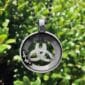A celtic trinity necklace with a celtic symbol on it.