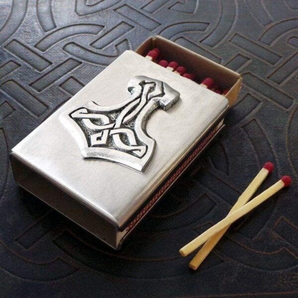 A matchbox with a thor symbol on it.
