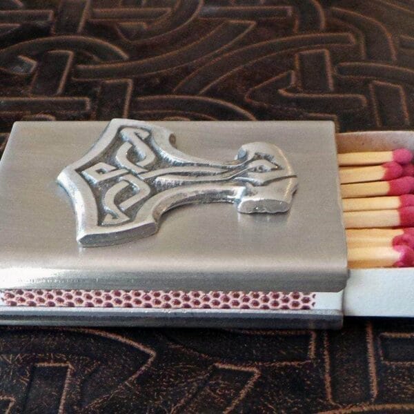 A matchbox with a thor hammer on it.