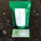 A green tea bag with a business card on it.