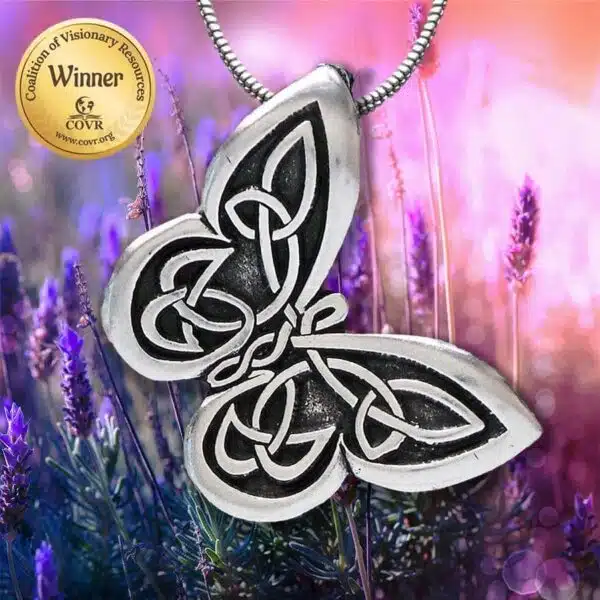 A silver butterfly pendant with a celtic design on it. A silver butterfly pendant with a celtic design on it.