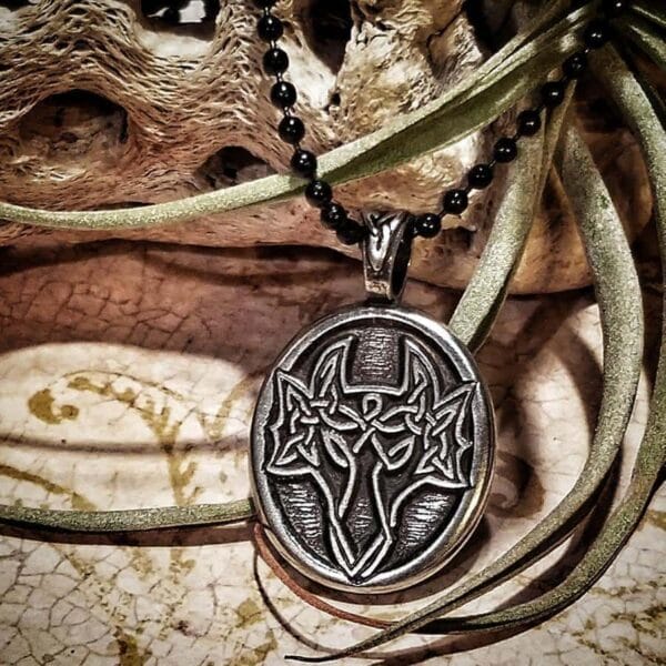 A pendant with a skull and crossbones on it.