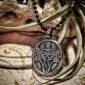 A pendant with a skull and crossbones on it.