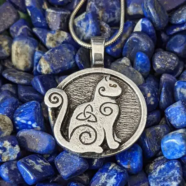 A celtic cat pendant on a blue stone. A celtic cat pendant on a blue stone.
