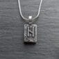 A sterling silver necklace with the letter n on it.