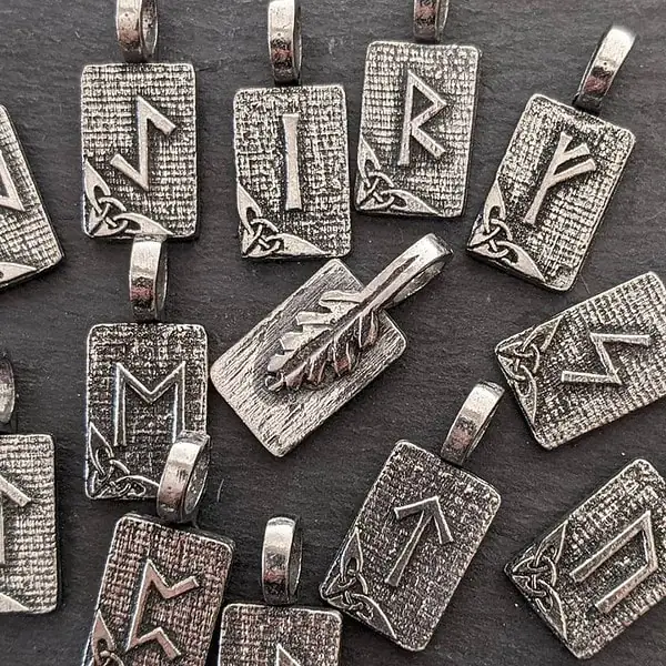 A group of sterling silver pendants with arrows on them.