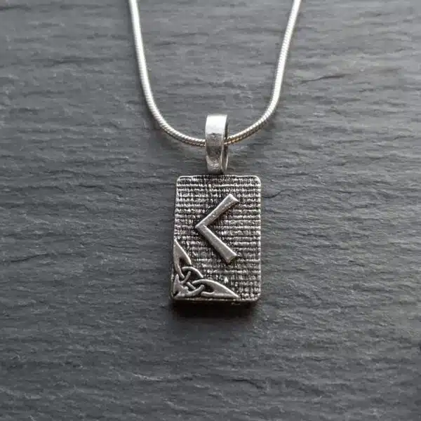 A silver necklace with a viking symbol on it.