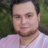 A man wearing a pink shirt.