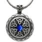 A celtic pendant with a blue stone.
