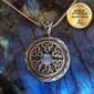 A celtic pendant with a moonstone on it.