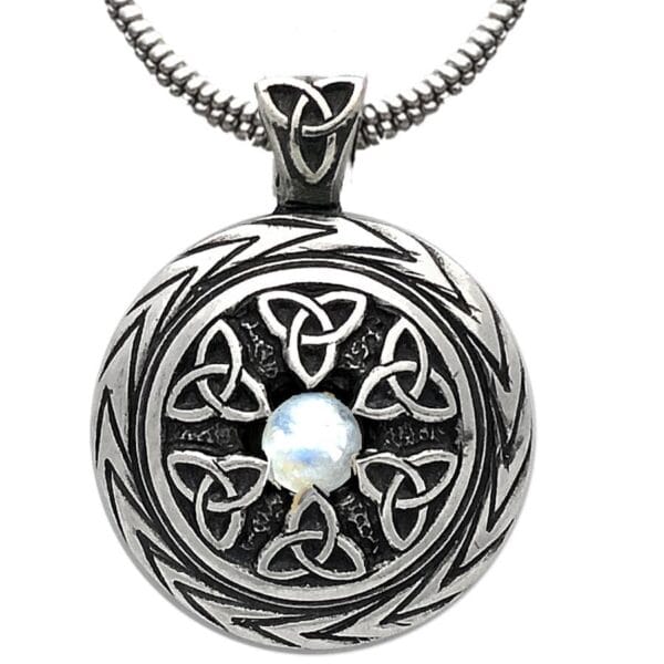 A celtic pendant with a moonstone on it.