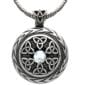 A celtic pendant with a moonstone on it.