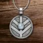 A silver pendant with a moonstone on it.