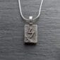 A silver necklace with the letter z on it.