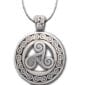 A silver pendant with a celtic design on it.