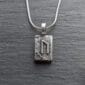 A sterling silver necklace with the letter n on it.