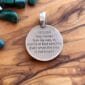 A round pendant with a quote that says, i may never be in storms or bad weather.