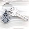A keychain with a celtic symbol on it.
