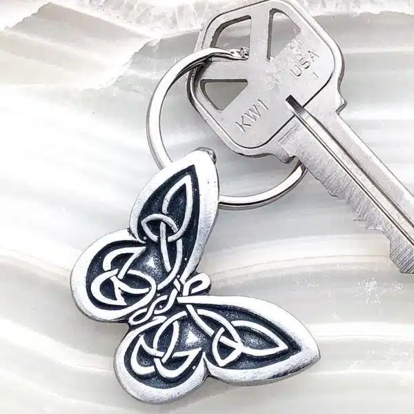 A keychain with a celtic design on it.