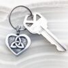 A keychain with a celtic heart on it.