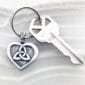 A keychain with a celtic heart on it.