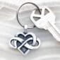 A heart shaped keychain with an infinity symbol on it.