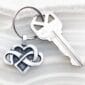 An infinity keychain with a heart on it.
