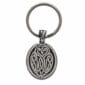 An owl keychain with a celtic design on it.