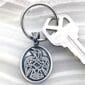 A key chain with a celtic eagle on it.