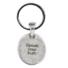 A silver keychain that says speak your truth.