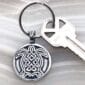 A key chain with a celtic turtle on it.