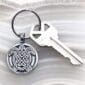 A keychain with a celtic design on it.