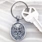 A key chain with a wolf design on it.