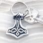 A key chain with a thor hammer on it.