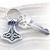 A key chain with a thor symbol on it.