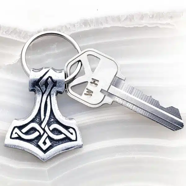 A key chain with a thor symbol on it. A key chain with a thor symbol on it.